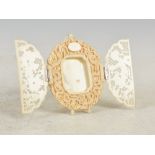 A Chinese Canton ivory photograph frame, Qing Dynasty, of shaped oval form with a pair of pierced