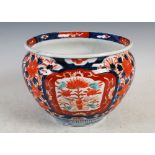 A Japanese Imari porcelain jardiniere, late 19th/early 20th century, decorated with shaped panels