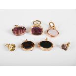 A collection of seven assorted 19th century yellow metal, blood stone, agate and paste set fobs/