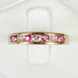 A 9ct gold, ruby and diamond half eternity ring, set with a row of four round faceted rubies,