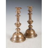 A pair of 19th century white metal baluster shaped candlesticks, with engraved foliate detail and