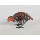 An early 20th century cold painted bronze figure of a female Red Grouse, 6cm high.