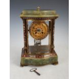 An early 20th century onyx and champleve enamel mantle clock, the circular dial with Arabic numerals