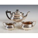 A George V three piece silver tea set, Birmingham 1923, tea pot with makers mark HJC, sugar bowl and