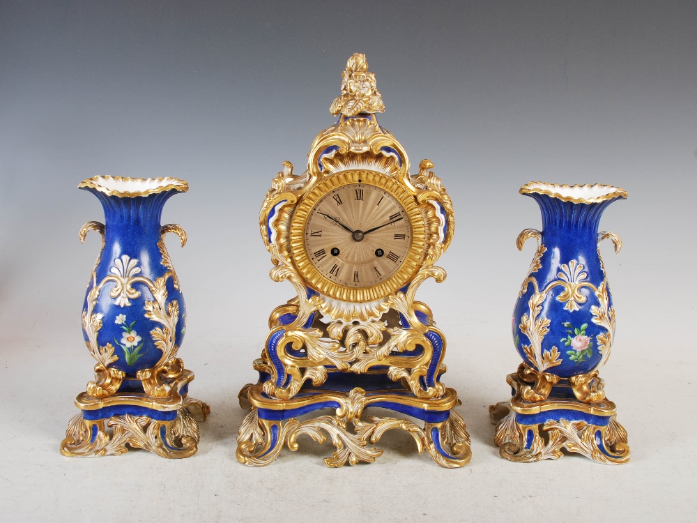 A 19th century French porcelain Rococo style clock garniture, Ed Honore, A, Paris, the mantel