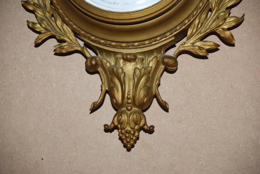 A late 19th/ early 20th century French gilt metal wall clock and matching barometer, both with white - Image 9 of 10