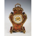 A late 19th century Boulle Rococo style gilt metal mounted mantle clock, the circular dial with