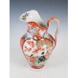 A Japanese Imari porcelain ewer, late 19th/early 20th century, decorated with shaped panels of
