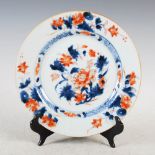 A Chinese porcelain Imari plate, decorated with peony in a diaper and foliate border, 22.5cm