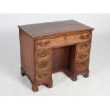 A George III mahogany knee hole desk, the rectangular top with a moulded edge above a long