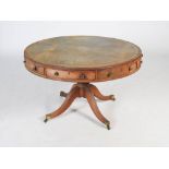 A George III mahogany drum table, the circular top with green and gilt tooled leather insert,