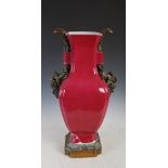 An impressive 19th century Continental ormolu mounted puce ground porcelain vase, with foliate and