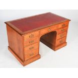 A Victorian oak pedestal desk, the rectangular top with red leatherette inset skiver, above a