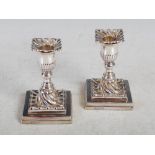 A pair of Victorian silver candlesticks, Sheffield 1880, makers mark of JKB, the urn shaped