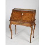 A Victorian burr walnut and gilt metal mounted bureau, the rectangular top with a pierced three