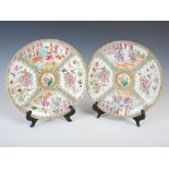 A pair of Chinese porcelain famille rose Canton plates, Qing Dynasty, decorated with panels of court