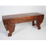 A large Chinese dark wood console table, early 20th century, the rectangular top above a deep frieze