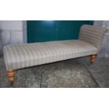 A 19th century satin birch chaise longue, with upholstered scroll end and seat, raised on baluster