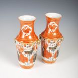 A pair of Chinese porcelain coral ground vases, late 19th/early 20th century, decorated with