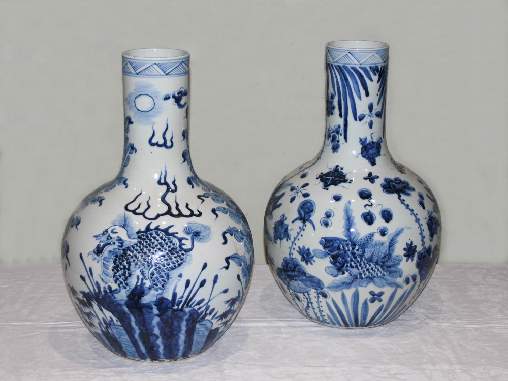A pair of decorative Chinese blue and white porcelain bottle vases, decorated in the Ming style with