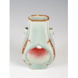 A Chinese porcelain Hu form celadon ground vase, decorated with peaches, 12.5cm high.