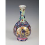 A Chinese porcelain blue and white pear-shaped vase, Qing Dynasty, with later 'clobbered'