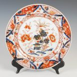 A Chinese porcelain Imari plate, Qing Dynasty, decorated with pavilion within a garden of peony