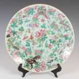 A Chinese porcelain celadon ground famille rose Canton plate, Qing Dynasty, decorated with peony,