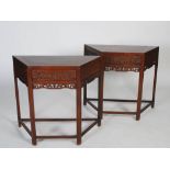 A pair of Chinese dark wood console tables, late 19th/early 20th century, the trapezium shaped panel