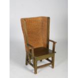 A late 19th/early 20th century stained pine Orkney chair, raised on tapered square supports united