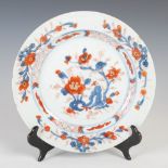 A Chinese porcelain Imari plate, Qing Dynasty, decorated with rockwork issuing peony, within