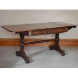 A Regency rosewood, brass inlaid and gilt metal mounted sofa table, the rectangular top with twin