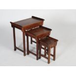 A nest of three Chinese dark wood occasional tables, late 19th/early 20th century, the panelled