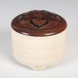 A Chinese monochrome glazed porcelain censer and pierced wood cover, the circular censer with