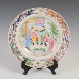 A Chinese porcelain famille rose dish, Qing Dynasty, decorated with Court figures on a terrace,