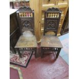 Pair of antique oak hall chairs with carved figure backs