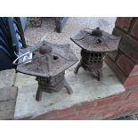 Pair of cast iron Oriental themed candle holders