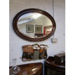 Large oval mahogany framed & bevelled glass wall mirror and another