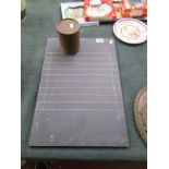 Slate 'shove halfpenny board' and container of counters