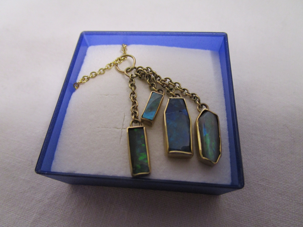 Gold necklace with 4 black opals