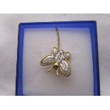 Gold diamond set butterfly on gold chain