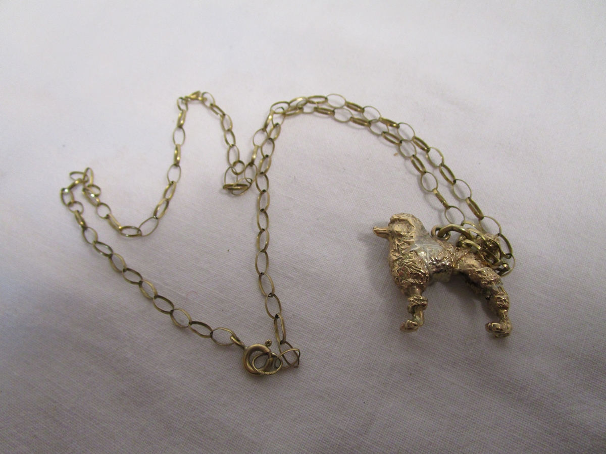 Gold poodle on chain