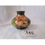 Moorcroft vase, Hibiscus pattern on green background, bulbous shape