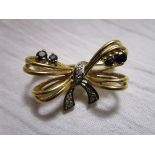 Gold diamond and sapphire set bow brooch