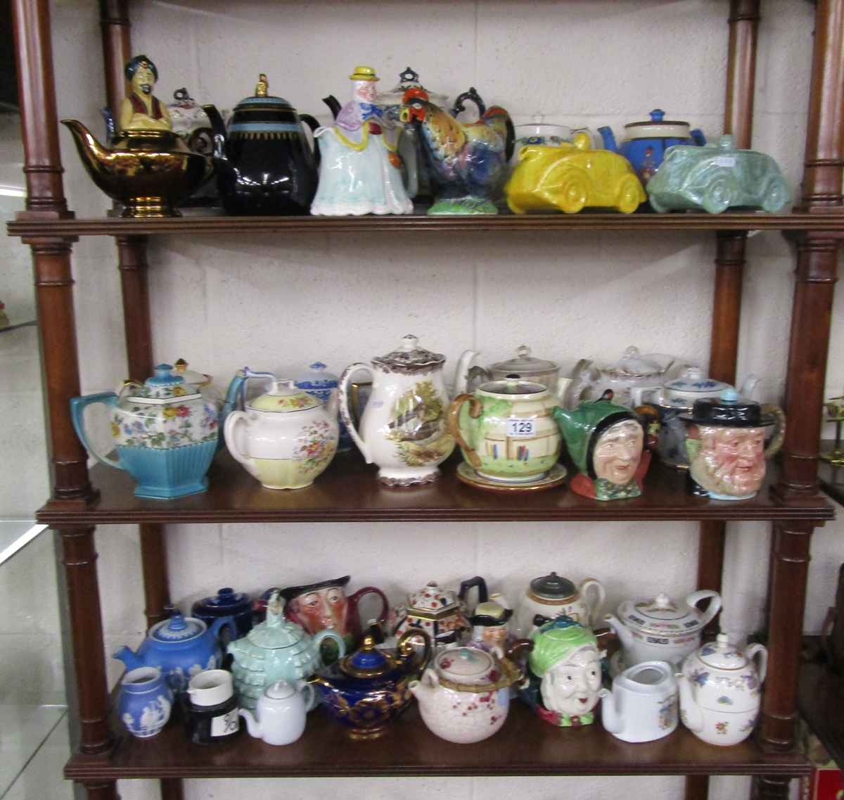 3 shelves of novelty tea pot's to include Saddler & Beswick