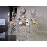 3 glass decanters, 1 with silver shoulder collar