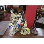 2 Oriental figures & another