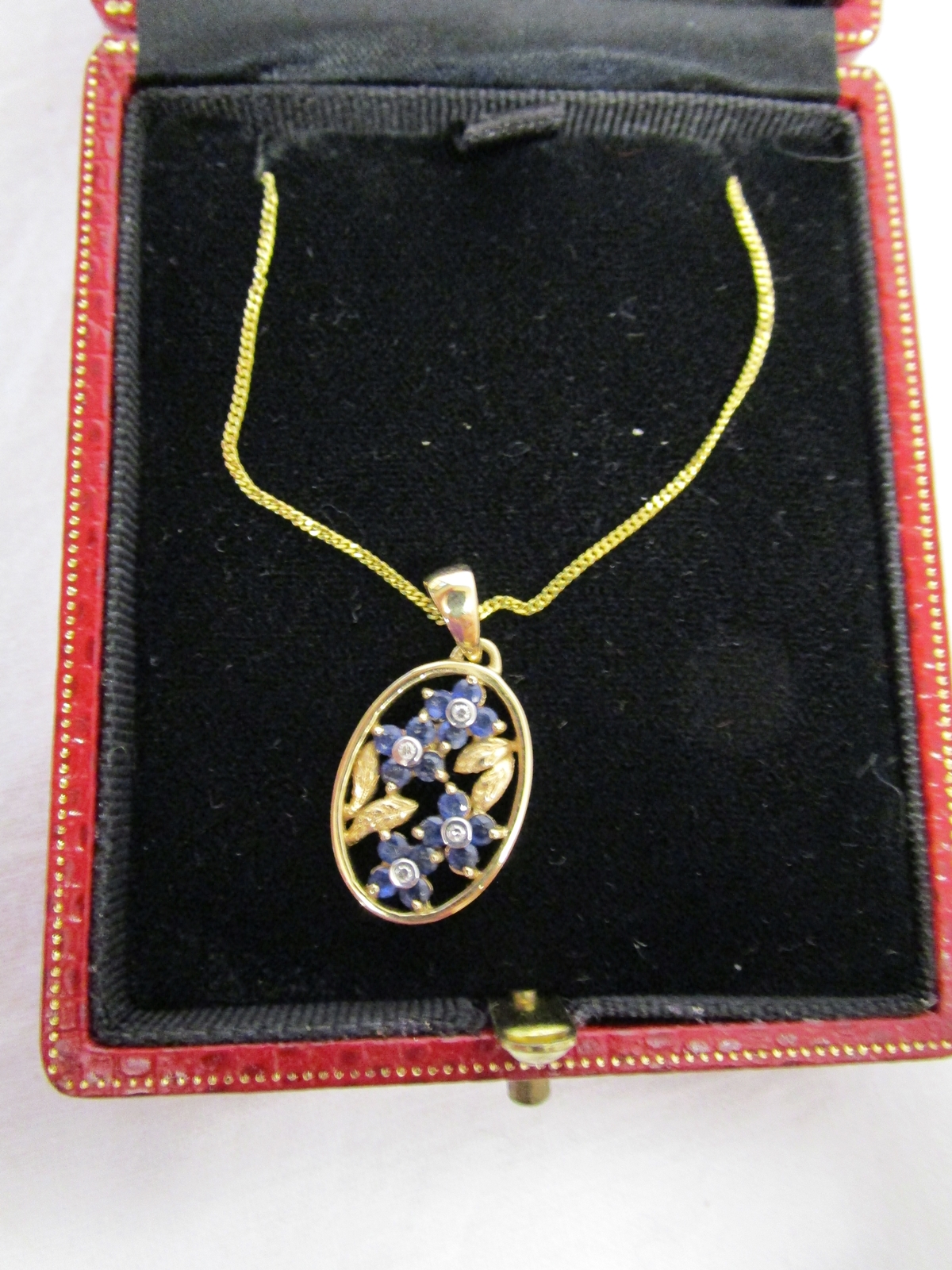 Gold Forget me knot sapphire & diamond pendant on gold chain