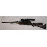 Gas powered air rifle with telescopic sight