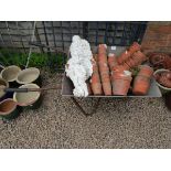 Wheelbarrow full of small terracotta plant pots & 2 cherub figures